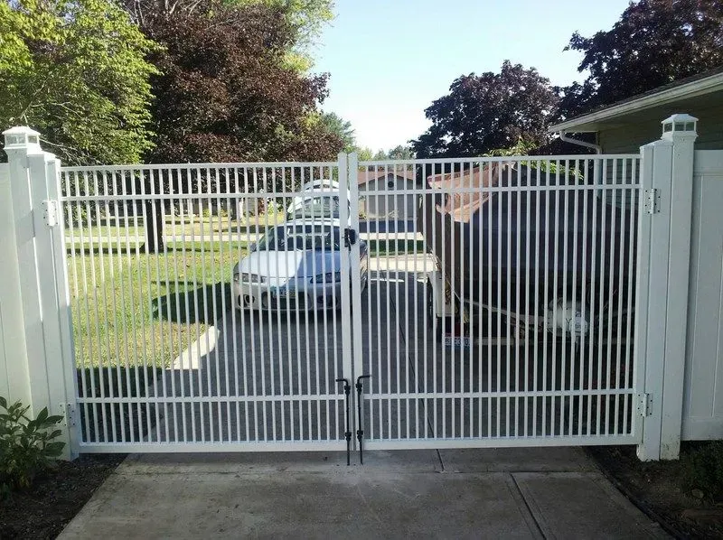 A white aluminum gate with a car parked behind it in Columbus