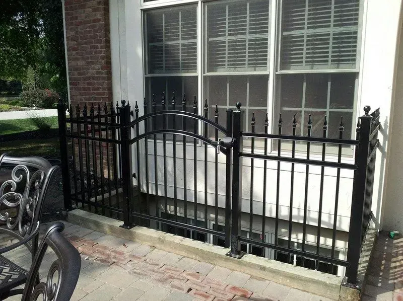 A black aluminum fence surrounds a window of a house in Columbus