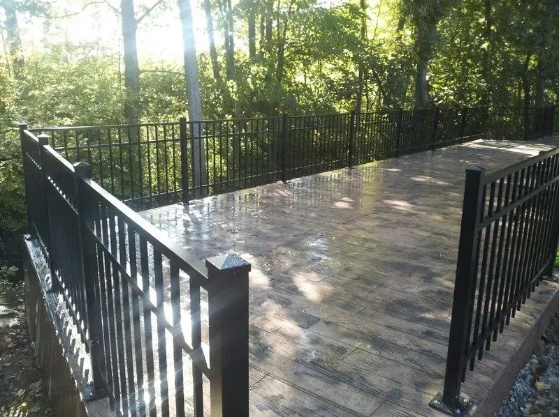 A patio with a black aluminium railing and trees in the background in Columbus