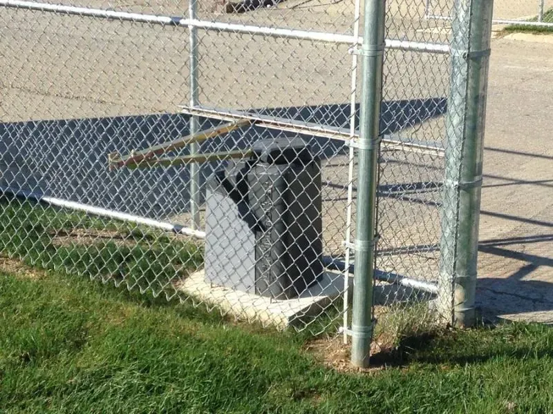 A chain link fence with a trash can behind it in Columbus