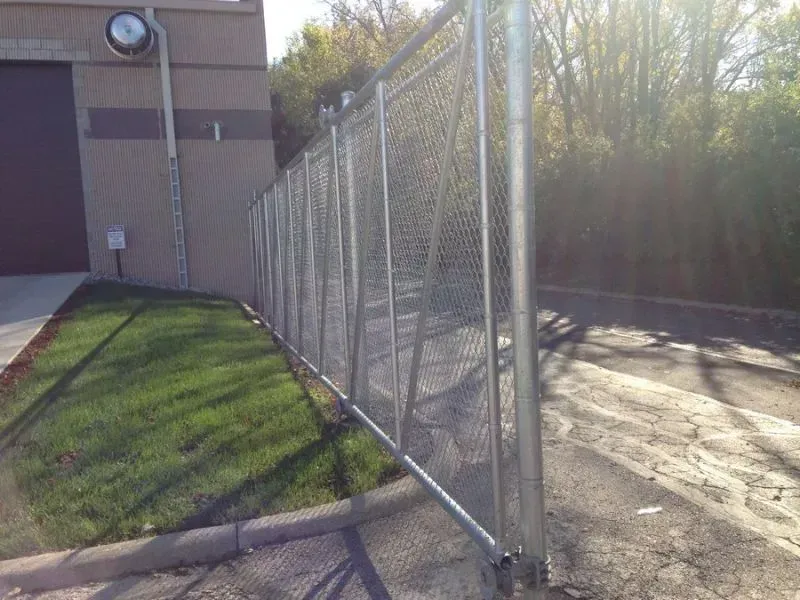 A chain link fence is sitting in front of a building in Upper Arlington