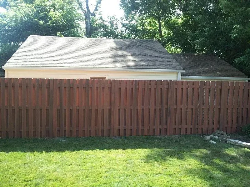 A wooden fence surrounds a shed in a backyard in Westerville