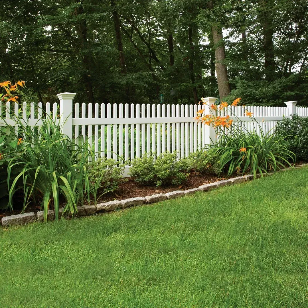 A white vinyl picket fence surrounds a lush green yard in Columbus