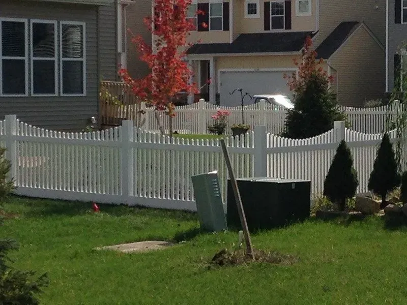 A white vinyl picket fence in front of a house in Columbus
