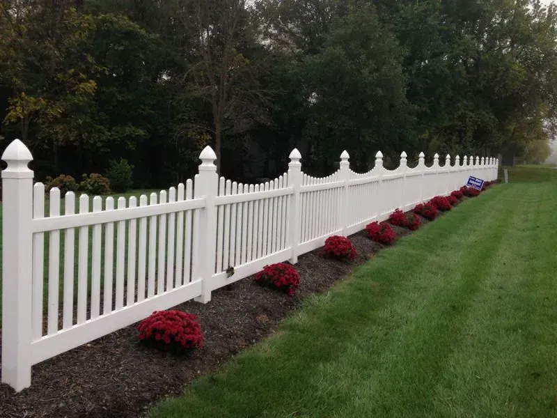 A white picket vinyl fence surrounds a lush green yard in Columbus