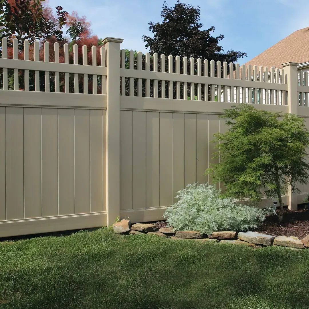 A white vinyl fence surrounds a lush green yard in Columbus