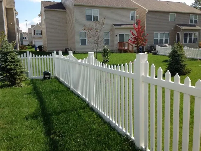 A white picket vinyl fence surrounds a lush green yard in Columbus