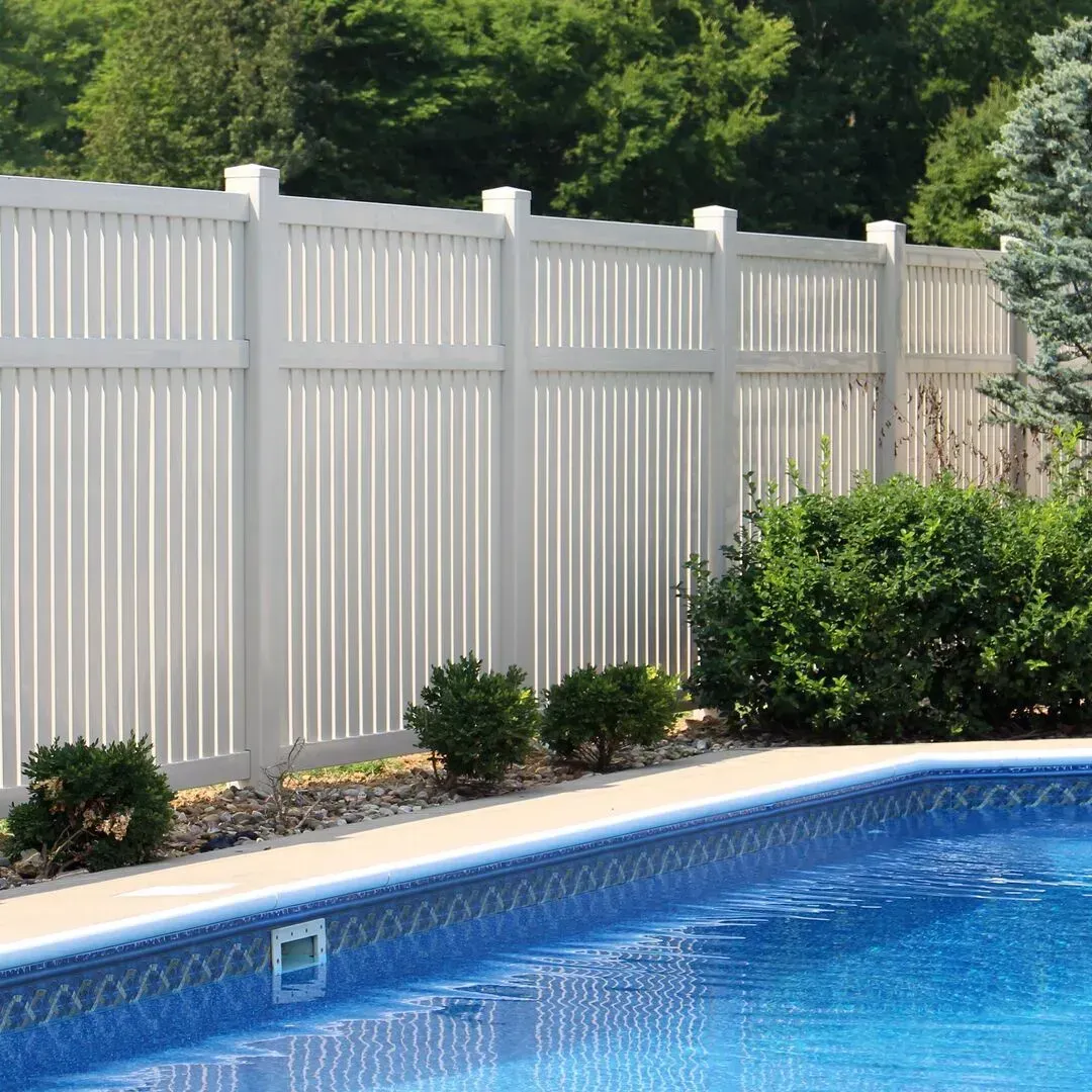A white vinyl fence surrounds a large swimming pool in Columbus