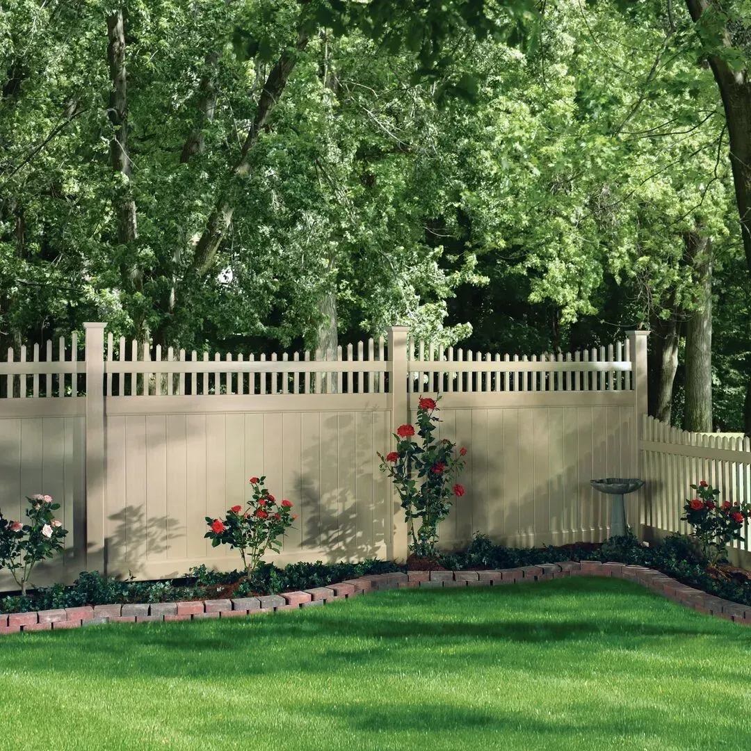 A white vinyl picket fence surrounds a lush green yard in Columbus