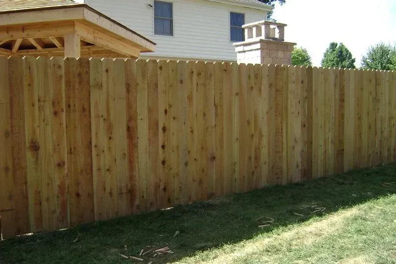 A wooden fence is in the backyard of a house in Columbus