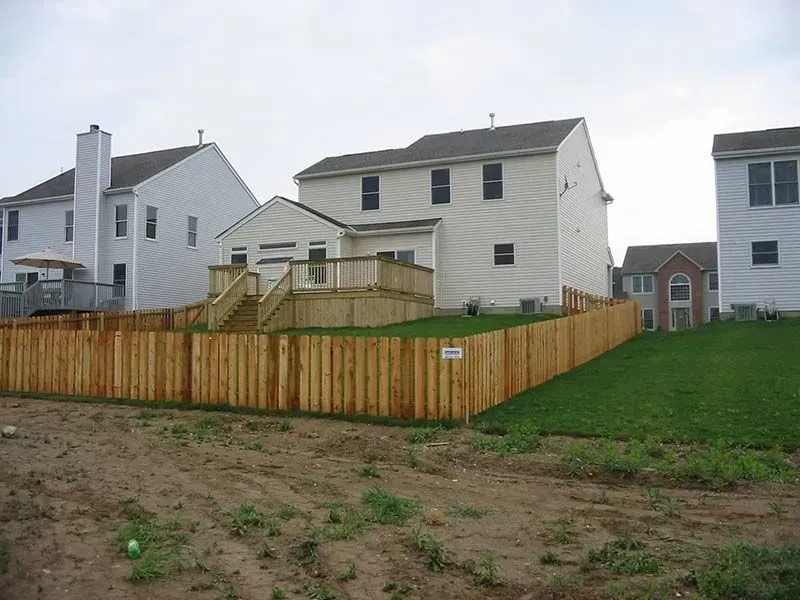 A wooden fence surrounds a house with a deck in Columbus