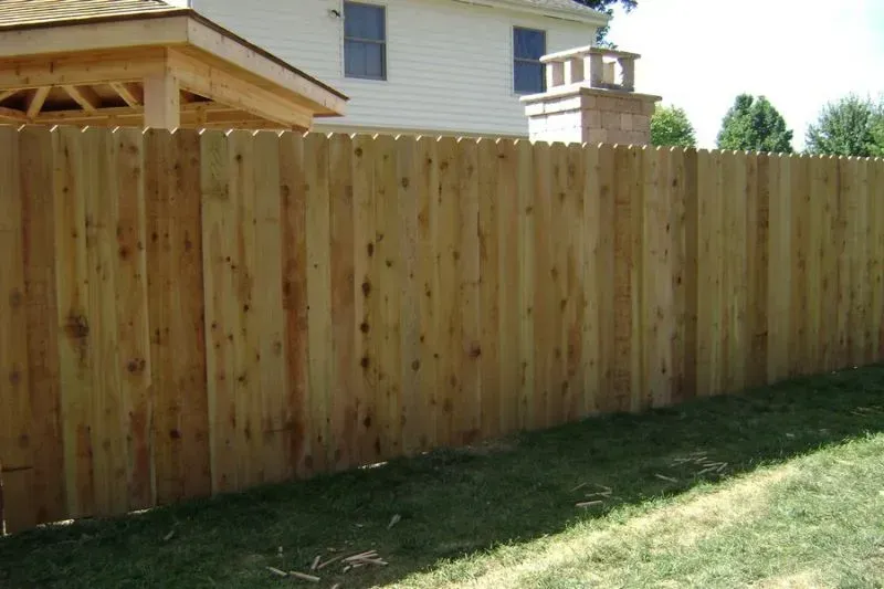 A wooden fence is in the backyard of a house in Columbus