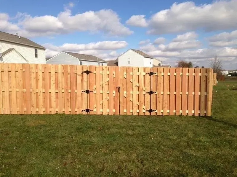 A wooden fence is in the middle of a grassy field in Columbus