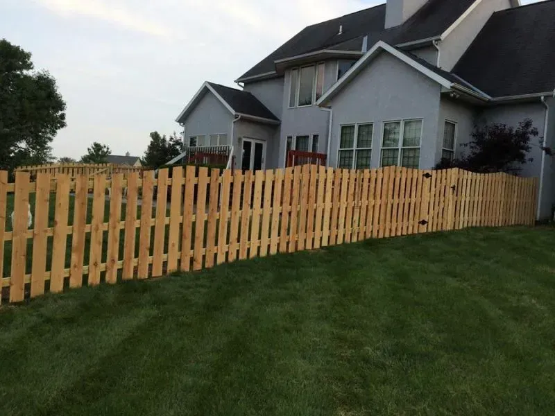 A large house with a wooden fence in front of it in Columbus