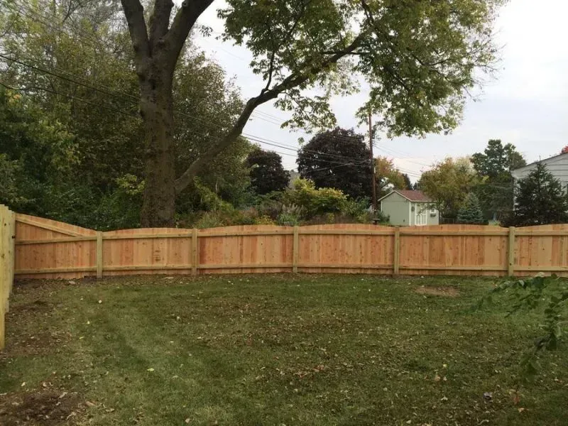 A wooden fence surrounds a lush green yard in Columbus