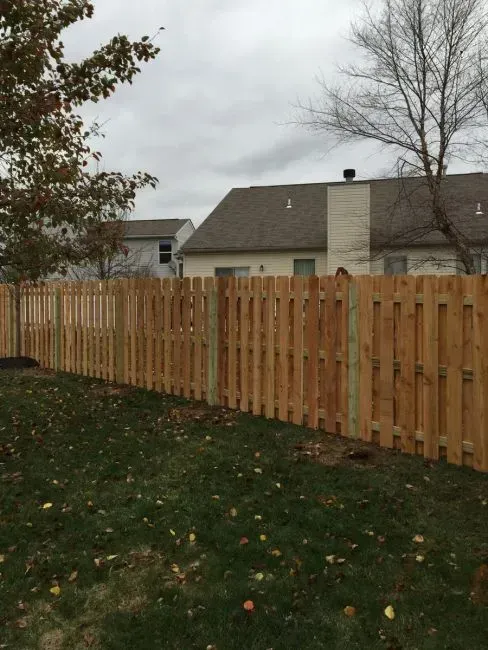 A wooden fence is in the backyard of a house in Columbus