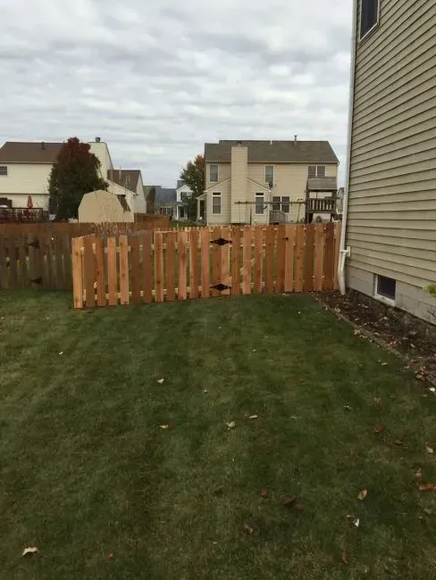 A wooden fence is in the backyard of a house in Columbus