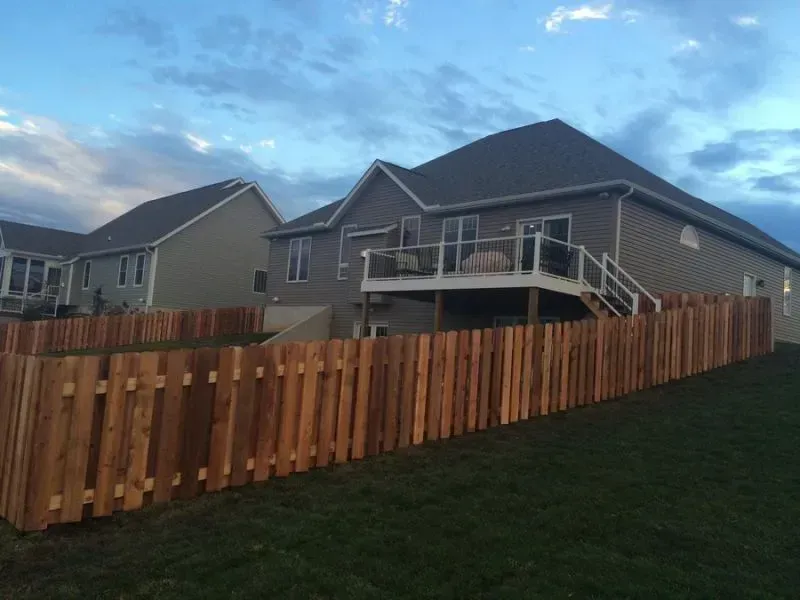 A house with a wooden fence in the front yard in Columbus