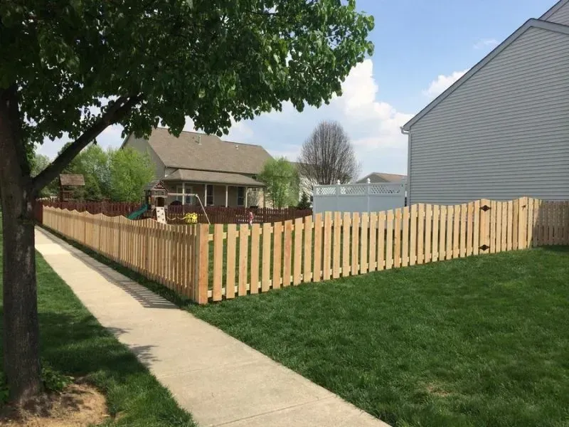 A wooden fence along a sidewalk in front of a house in Columbus