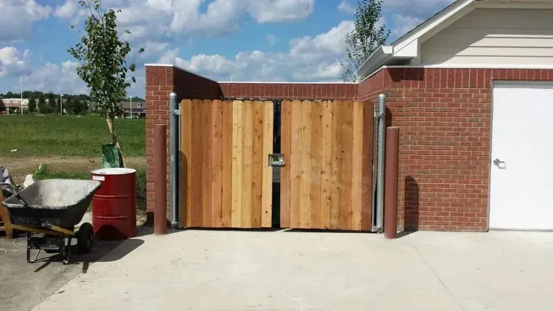 A wooden gate is sitting in front of a brick building in Columbus