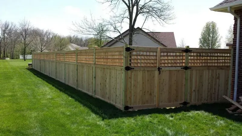 A wooden fence with a gate in the backyard of a house in Columbus