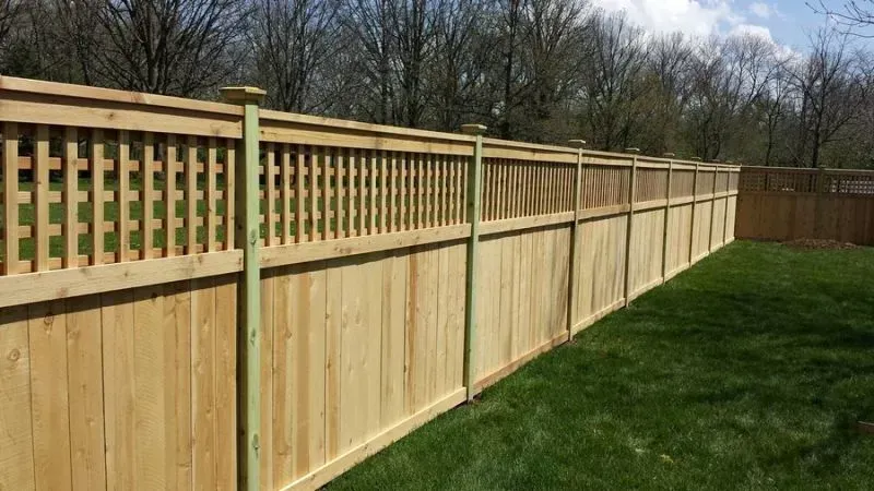 A white wood fence with a red barn in the background in Dublin