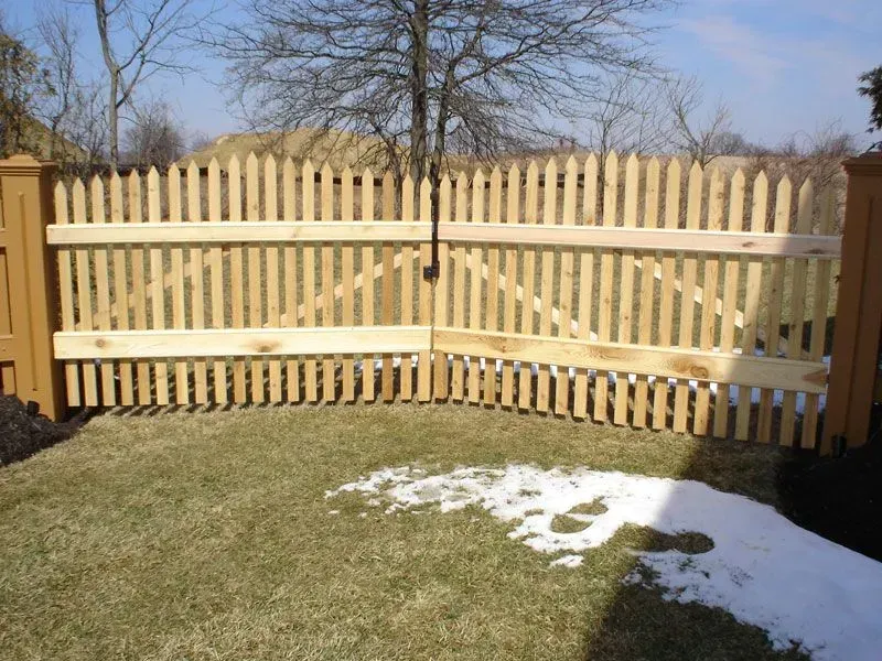 A wooden picket fence surrounds a lush green yard in Columbus