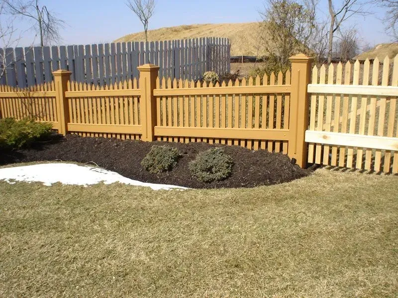 A wooden picket fence surrounds a lush green yard in Columbus