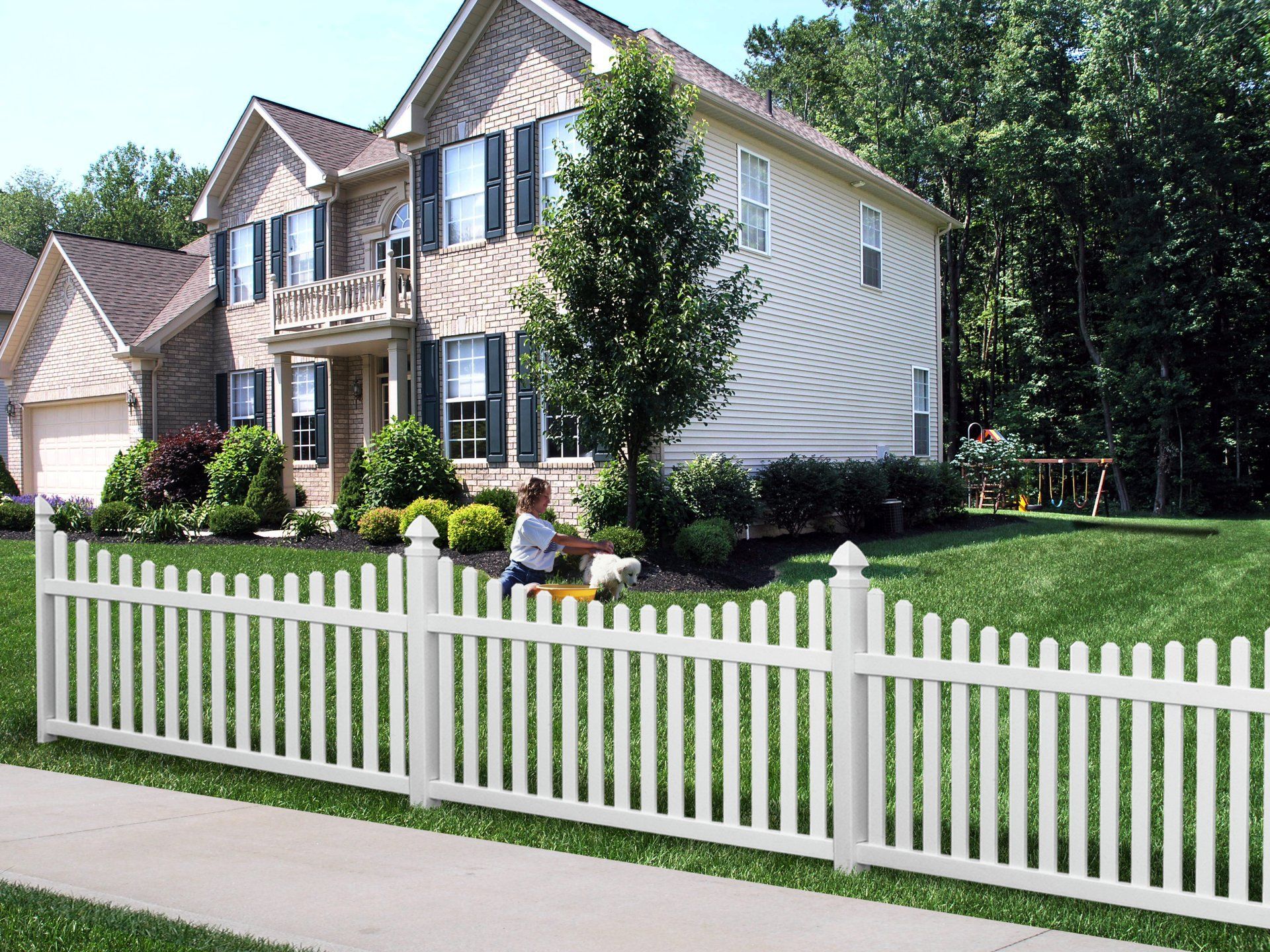 A white picket fence is in front of a house in Powell