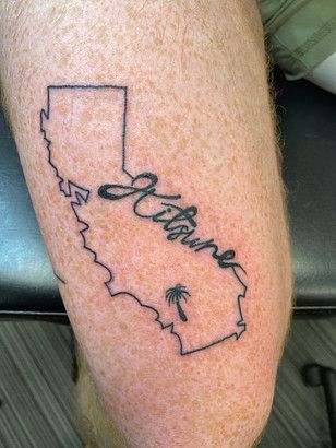 A person has a tattoo of a map of california on their leg.
