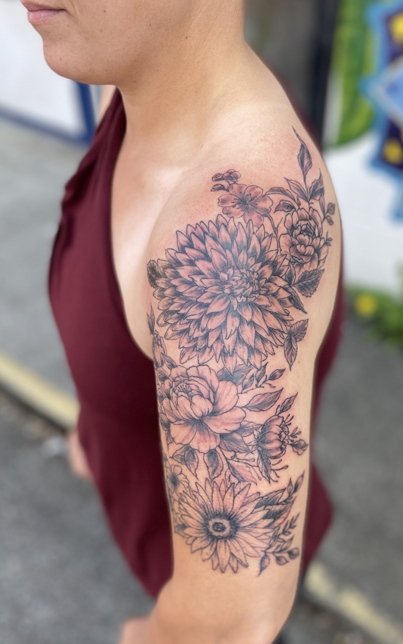 A woman has a tattoo of flowers on her arm