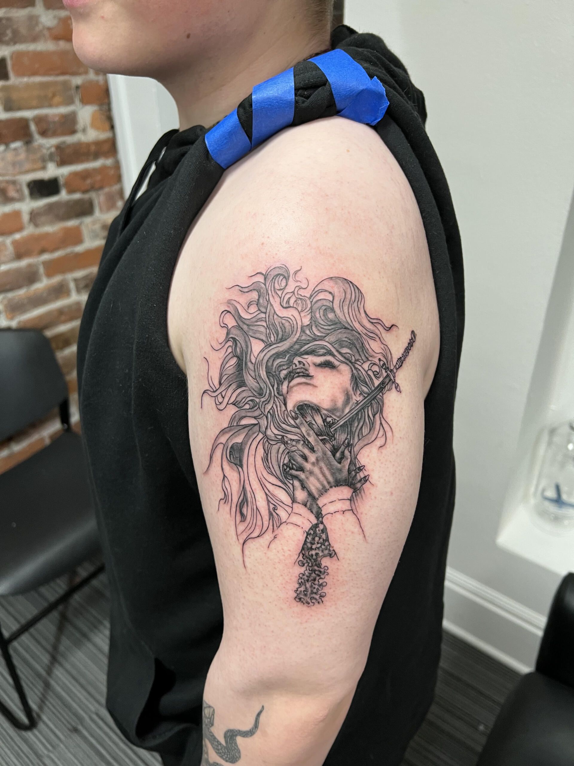black and grey tattoo of woman with sword 