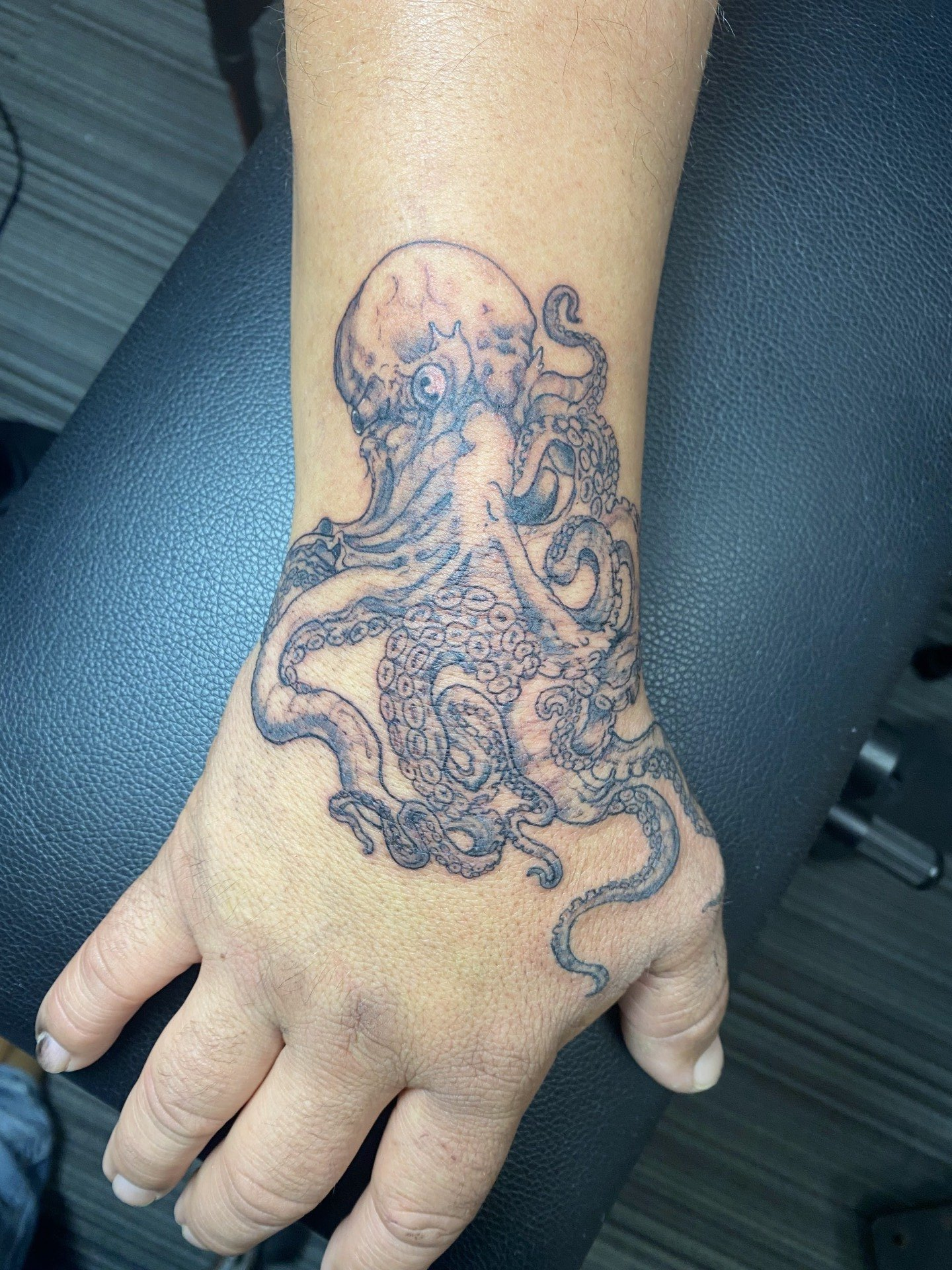 A woman has an octopus tattoo on her wrist