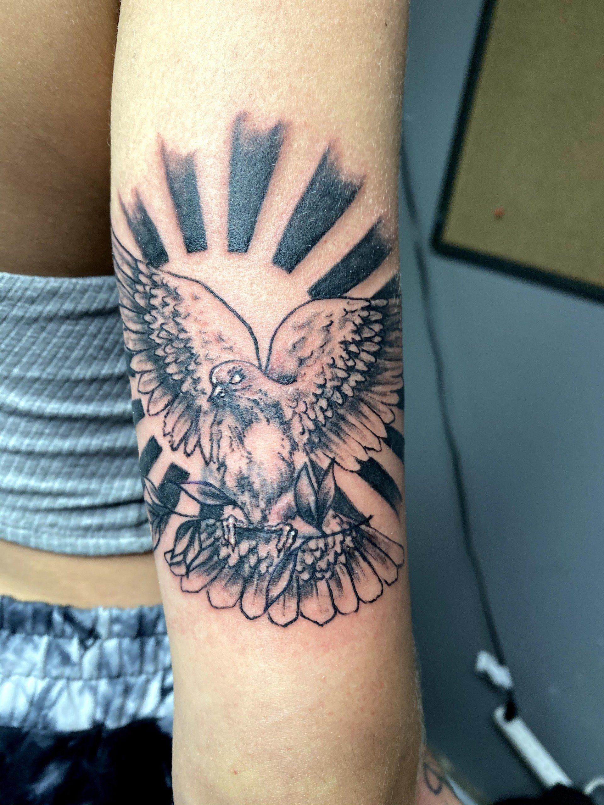 A woman has a tattoo of an eagle on her arm