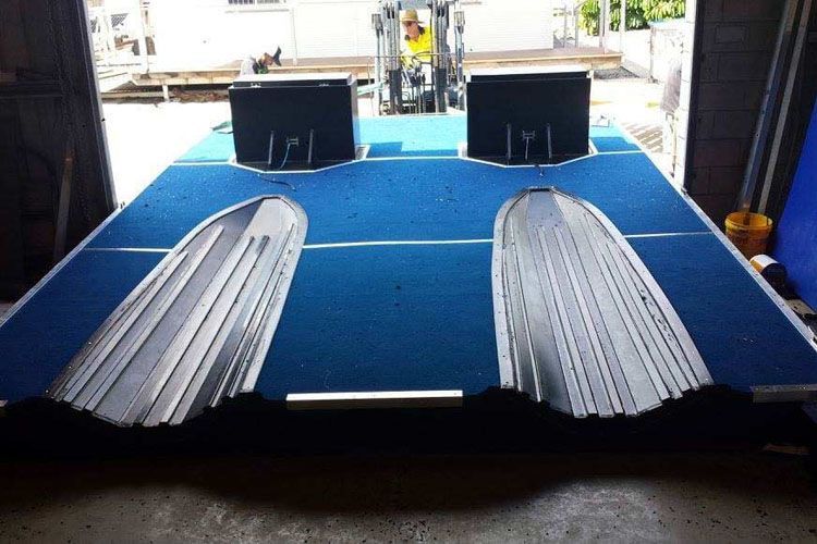 A Blue Carpeted Floor With a Few Boxes on It — V.I.P. Plastic Fabrication in Portsmith, QLD