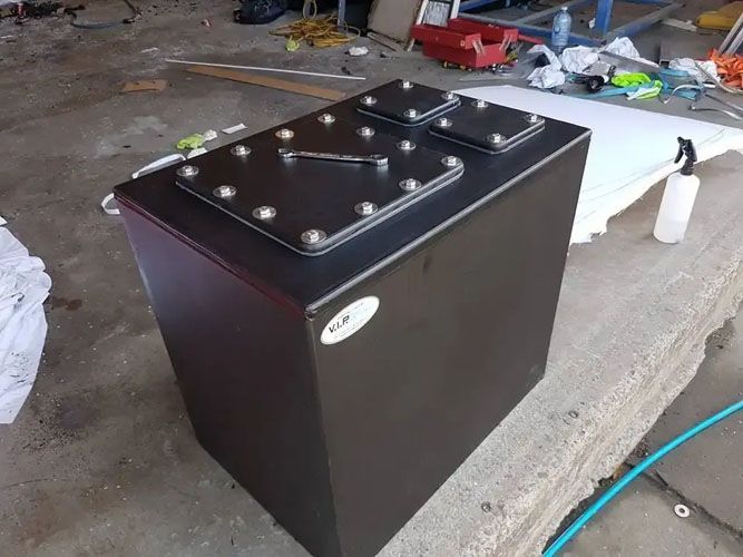 A Black Box is Sitting on a Concrete Surface Next to a Hose — V.I.P. Plastic Fabrication in Portsmith, QLD