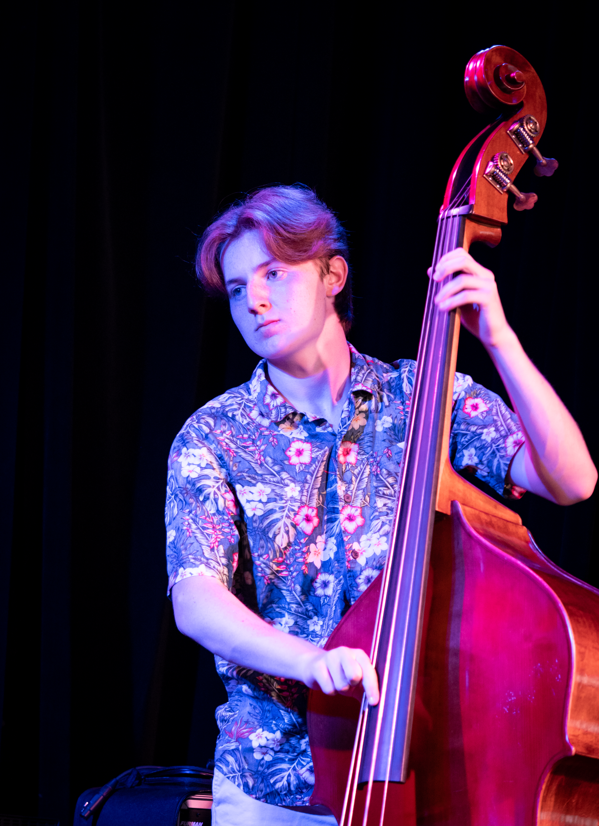 A high school student plays double bass in a jazz trio.