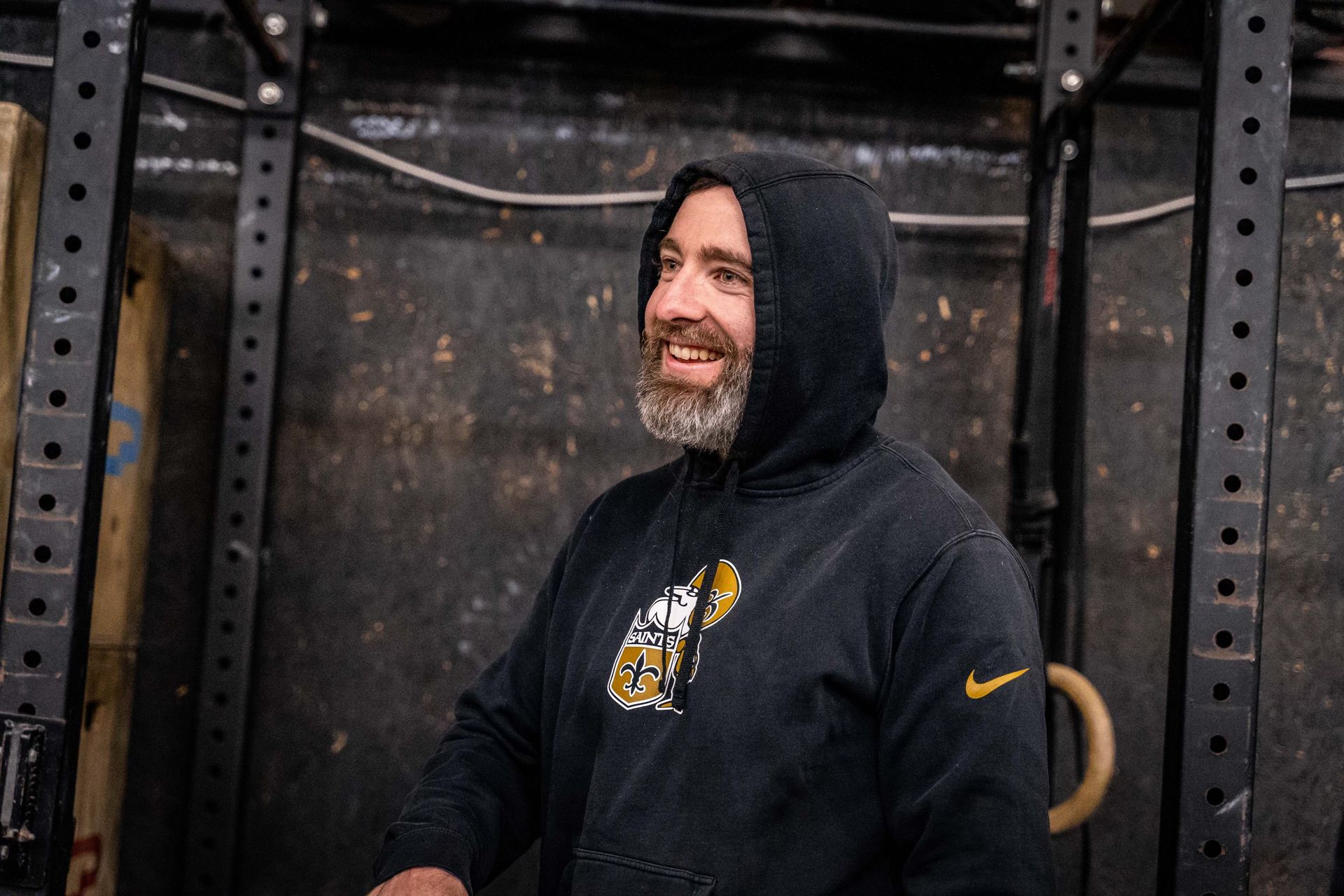 Coach Ryne Sullivan smiling in the gym