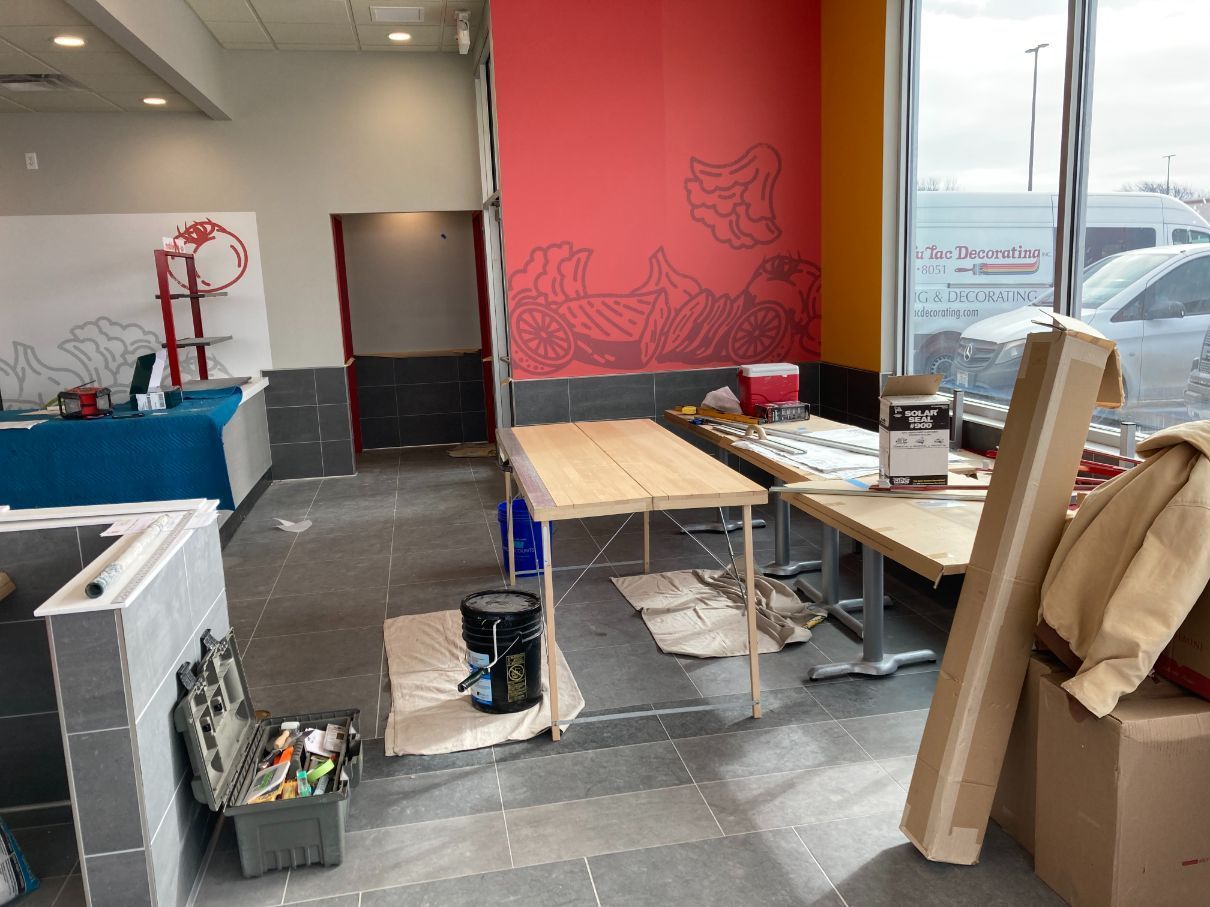 An empty room with a table and boxes on the floor.