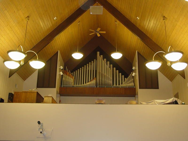 A church with a vaulted ceiling and a pipe organ