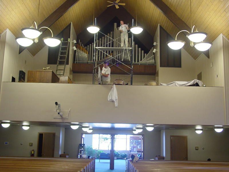 A man standing on a scaffolding in a church