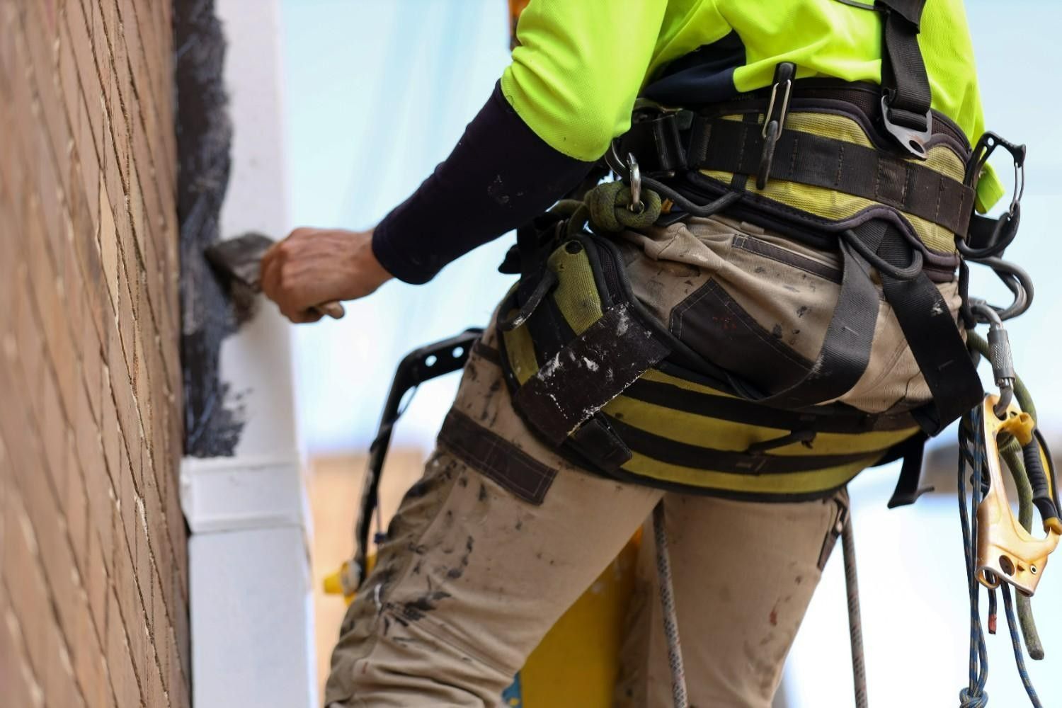 Person on Scaffolding Painting Exterior Wall, Wearing Safety Harness — A1 Painting NQ in Atherton, QLD