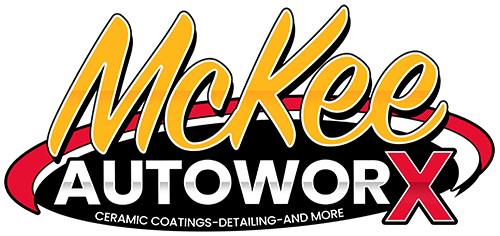 McKee Autoworx logo in yellow, red, black and white with a stylized red X