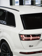 Rear view of a white Audi Q7 SUV featuring black trim, a tinted windows to lower cabin heat and protect from UV rays.