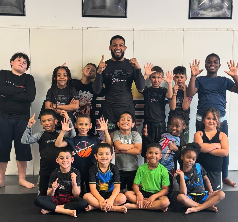 Kids practicing controlled grappling in a Youth Jiu-Jitsu class at 10th Planet Jiu-Jitsu Miami in Miramar, FL for calm confidence.