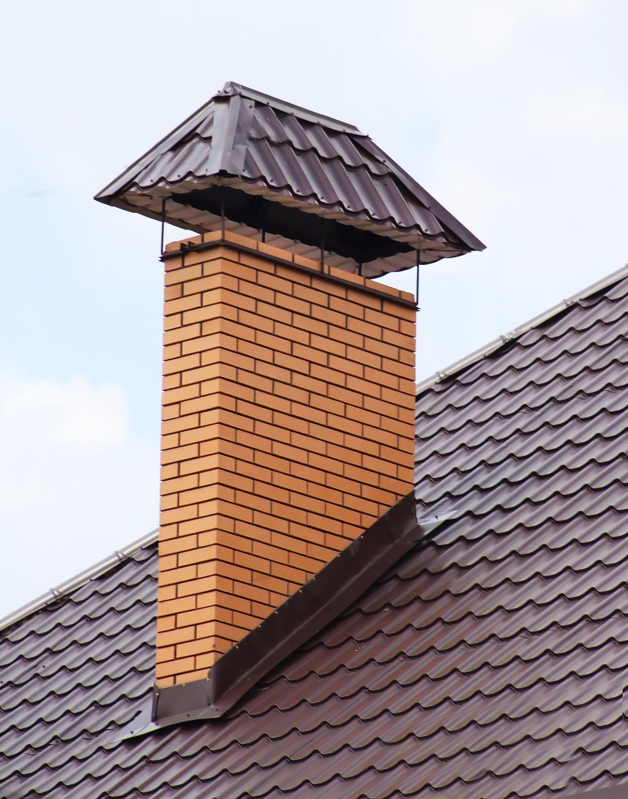 large single flue chimney cap on brick chimney
