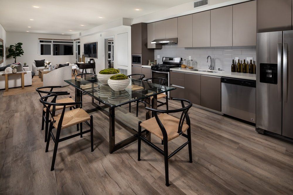 Modern apartment living room with large windows and natural light By Stoneridge Management Partners