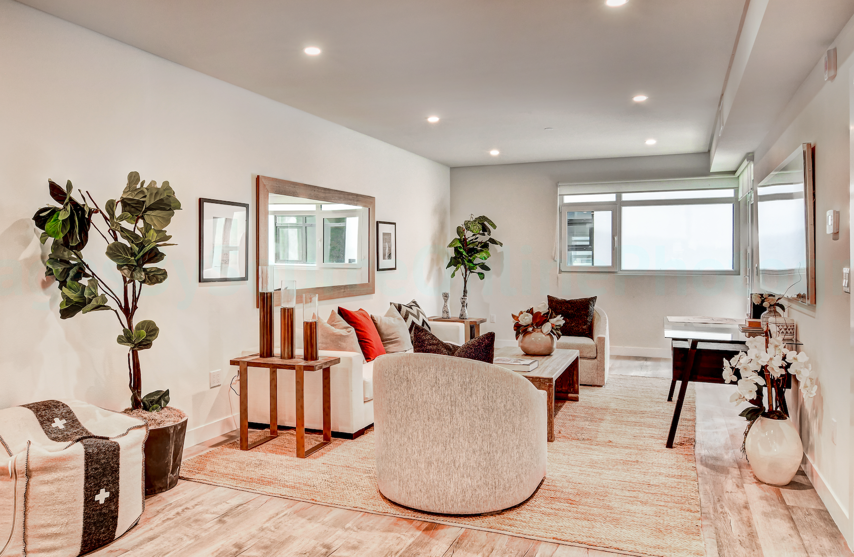 Modern apartment living room with large windows and natural light By Stoneridge Management Partners