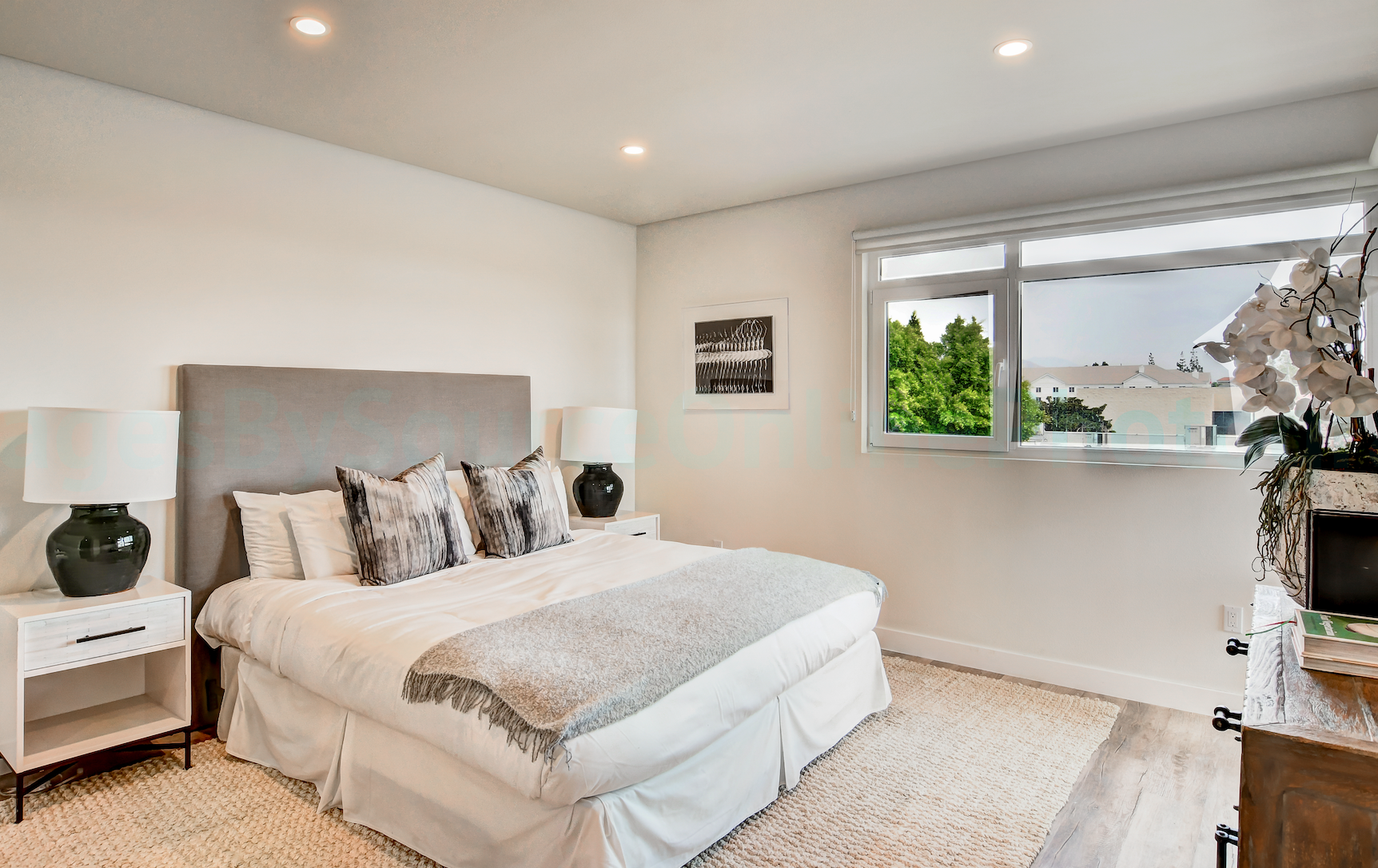 Modern apartment living room with large windows and natural light By Stoneridge Management Partners