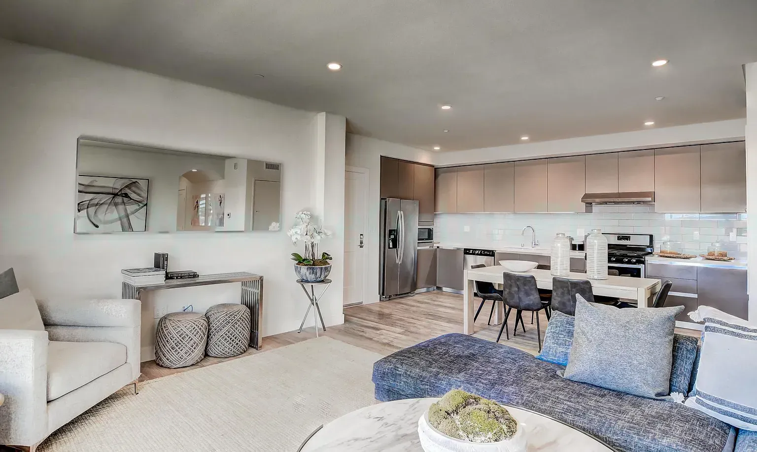 Modern apartment living room with large windows and natural light By Stoneridge Management Partners